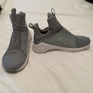 Women’s grey Puma sneakers.